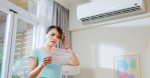 concerned woman looking at summer energy bill