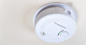 white carbon monoxide alarm on wall