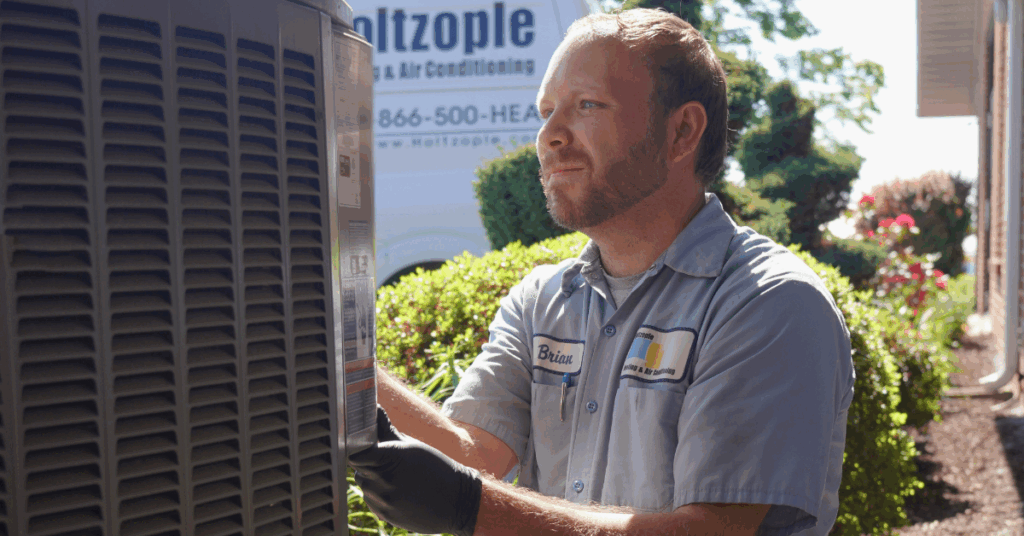ac unit maintenance being performed Holtzople HVAC technician