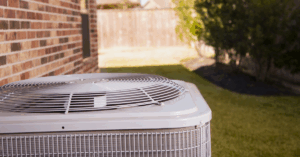 Air conditioner installed outside of a brick home.