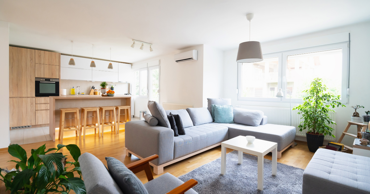Modern open concept living room and kitchen with an air conditioner