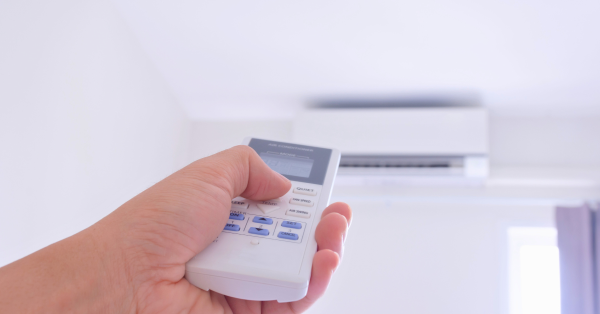 Remote being used to turn on an AC unit