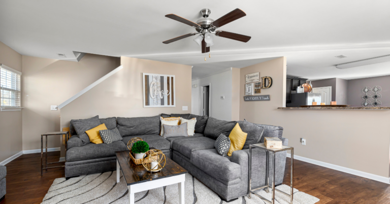 A modern living room with a large ceiling fan