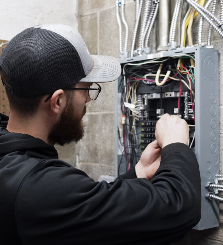 Braxton from Holtzople installing an electrical panel