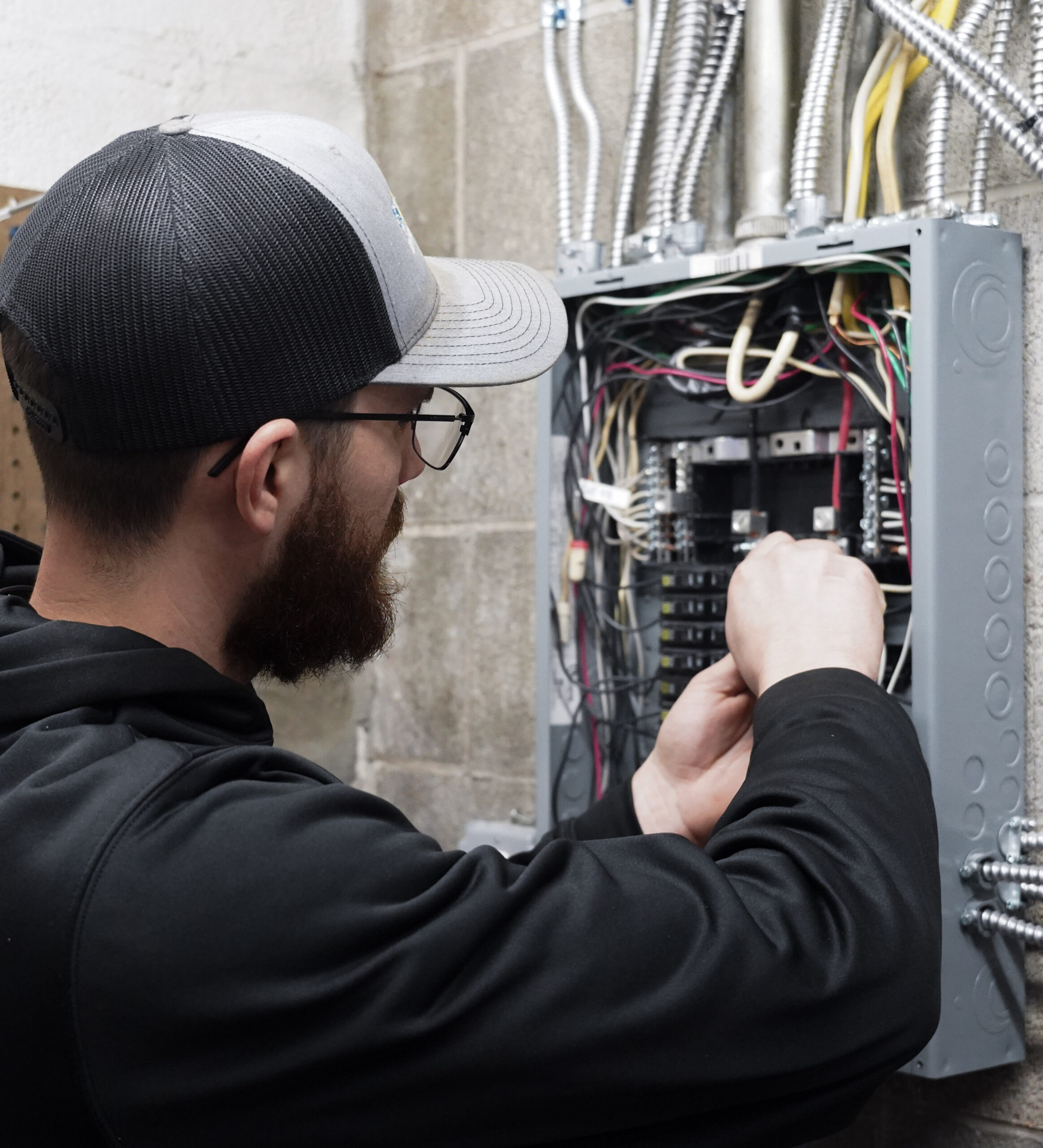 Braxton from Holtzople installing an electrical panel