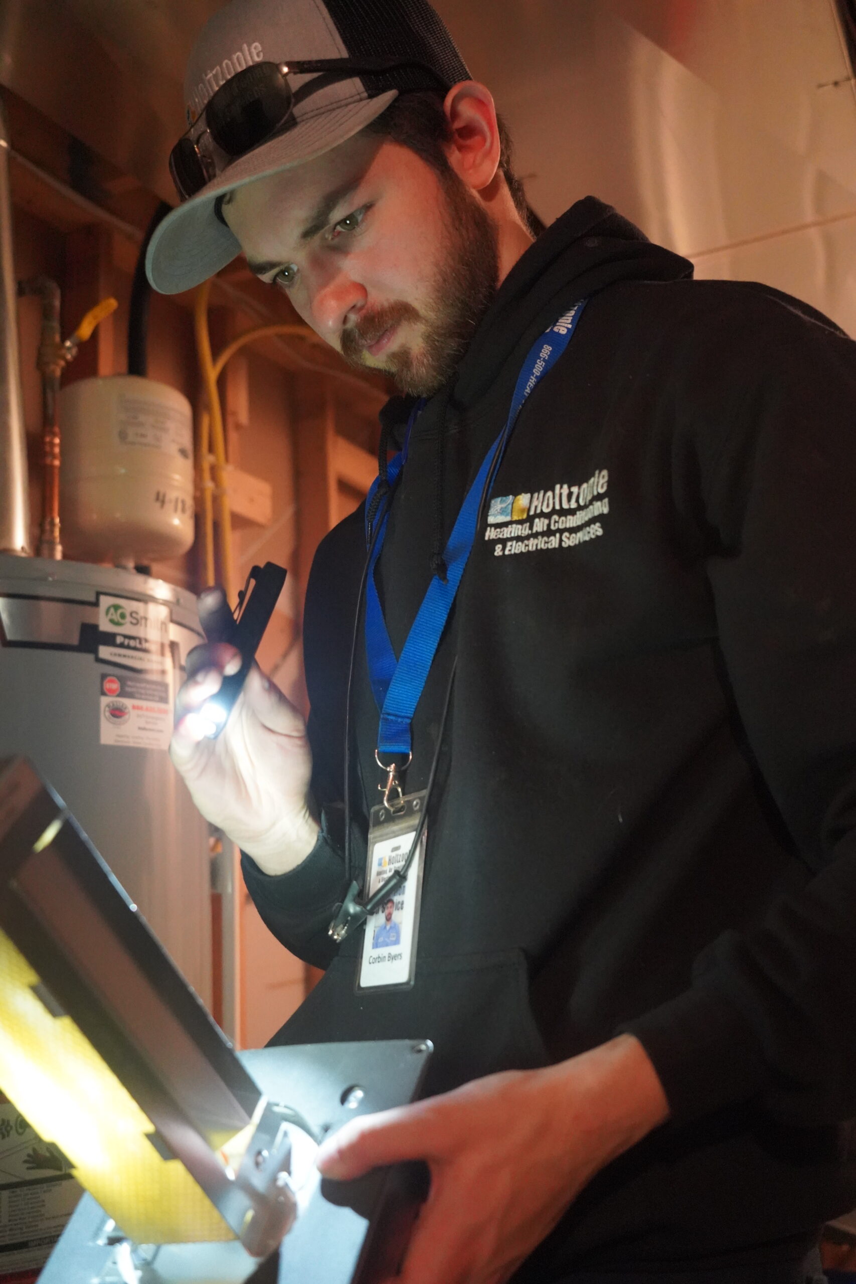 Holtzople service technician Corbin holding a UV light